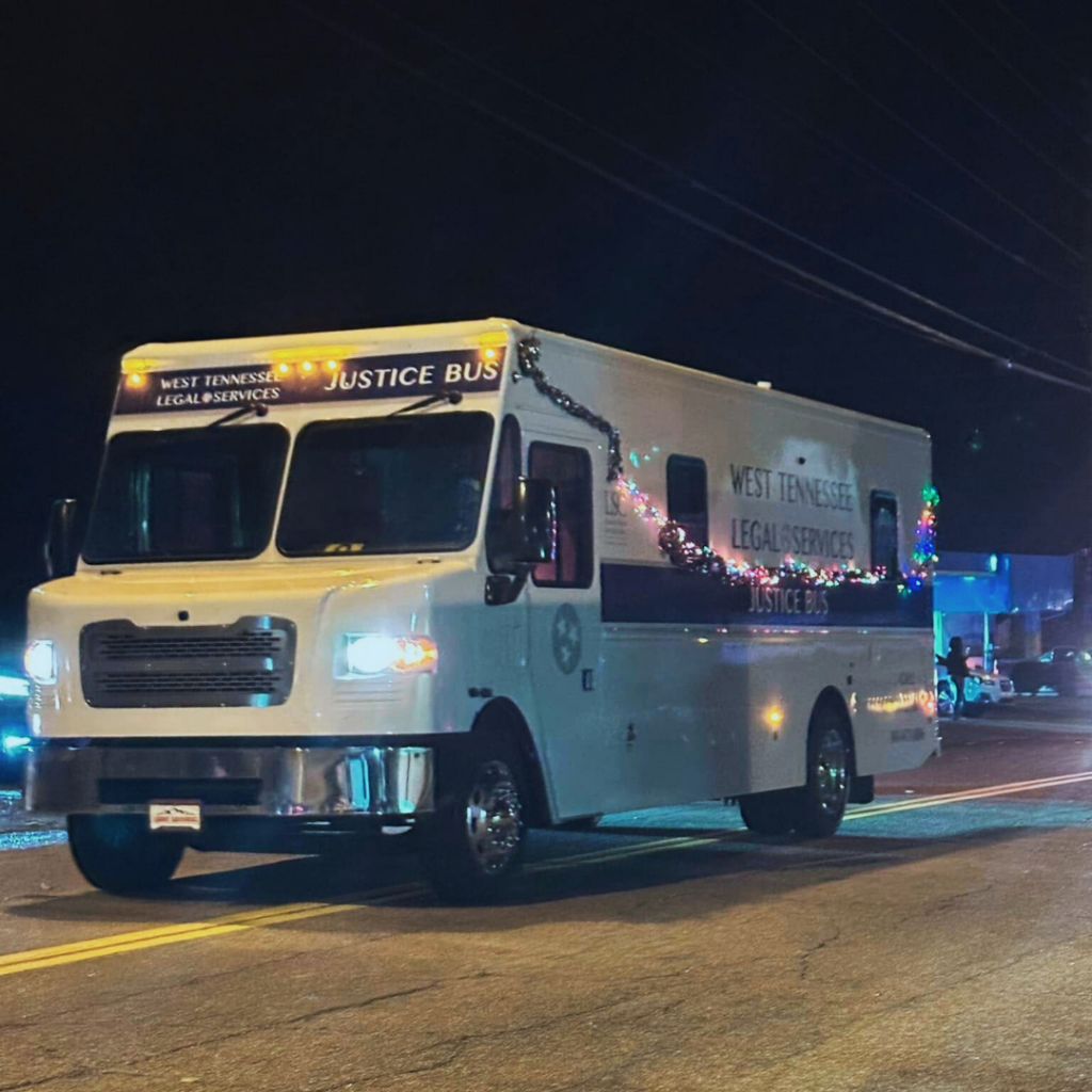 Picture of WTLS Justice Bus in Christmas Parade decorated with lights