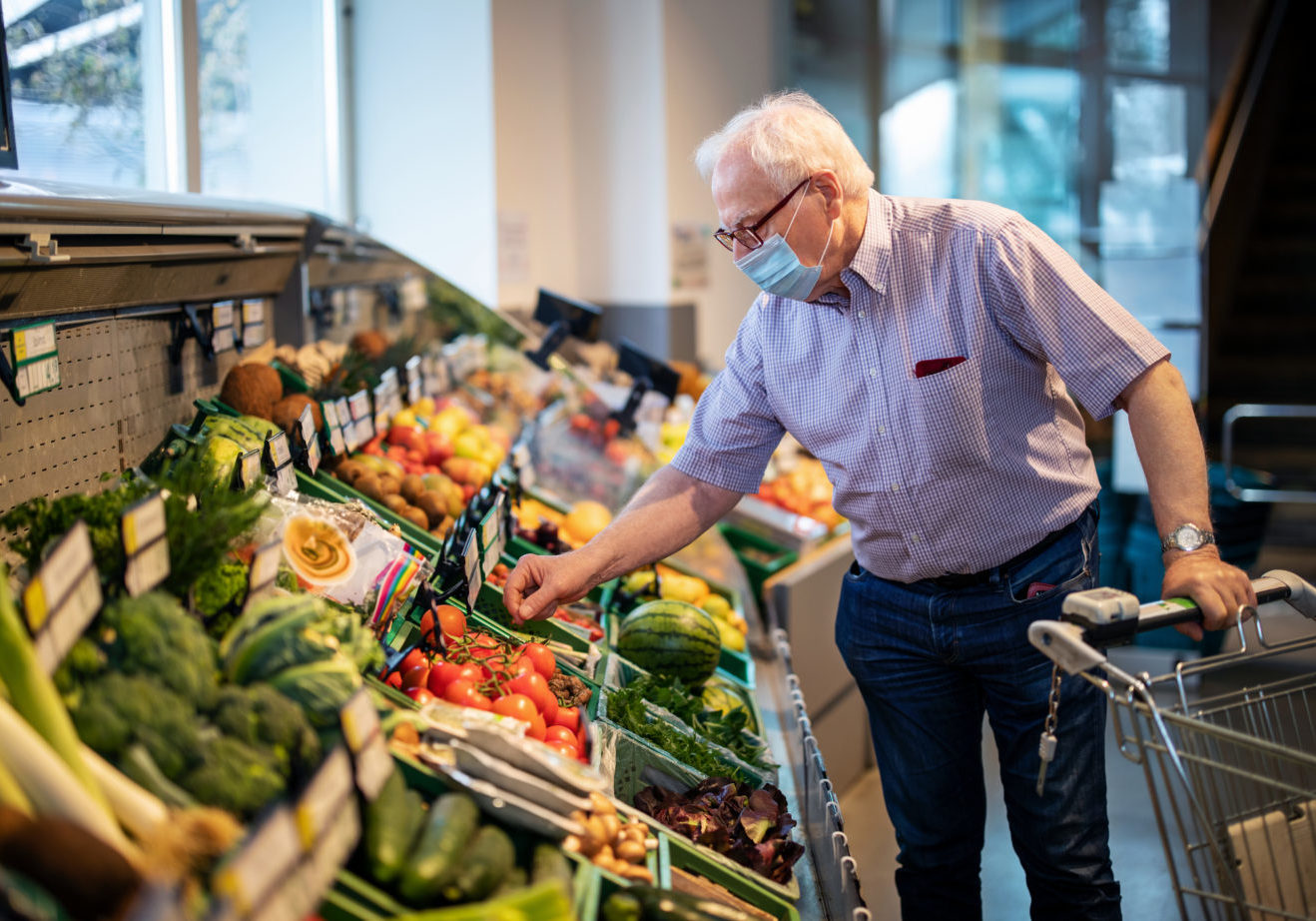 Senior Man With Face Mask Buying Vegetables In Grocery Store